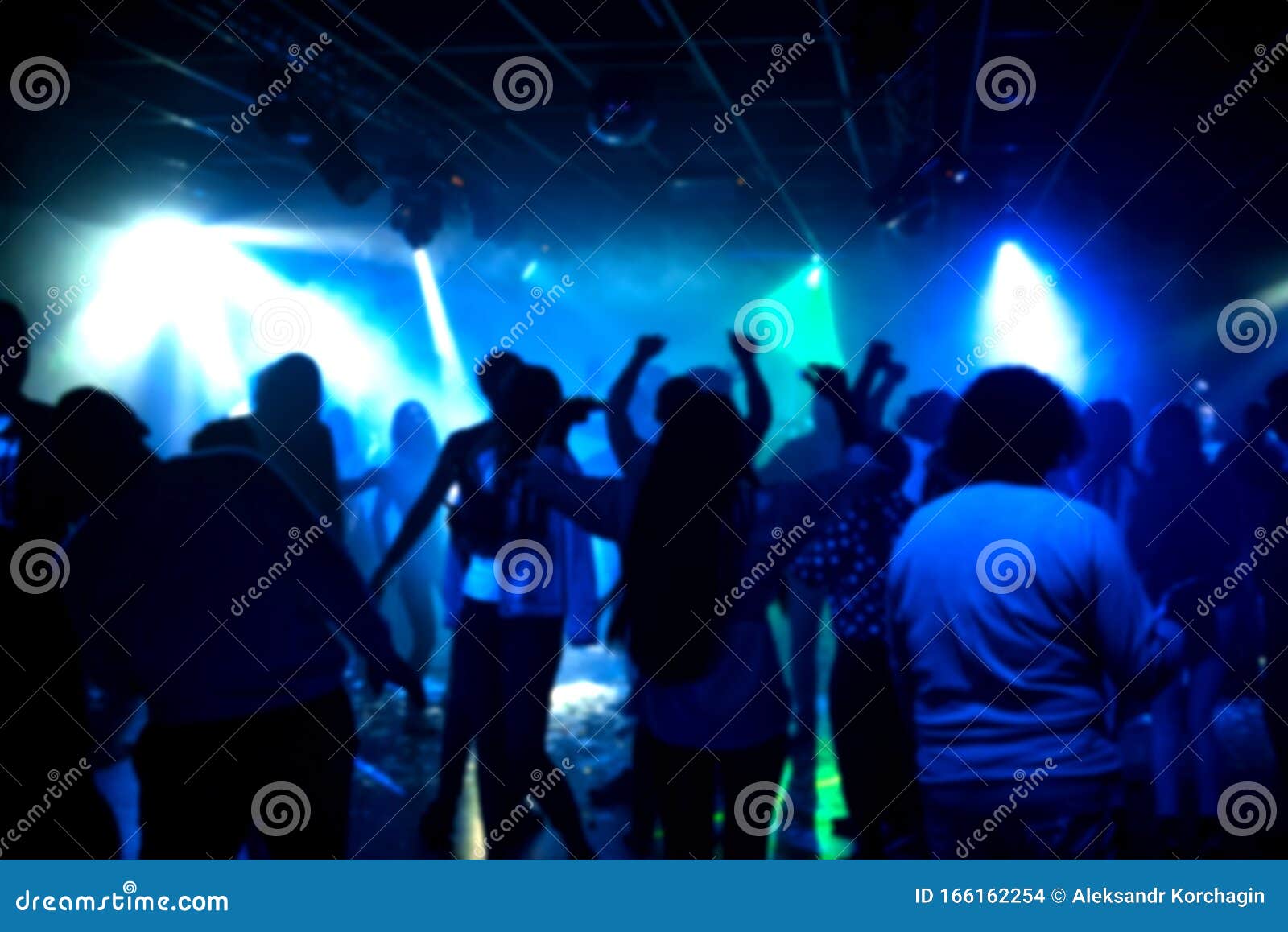 Blurred Silhouettes of a Group of People Dancing in a Nightclub on the ...