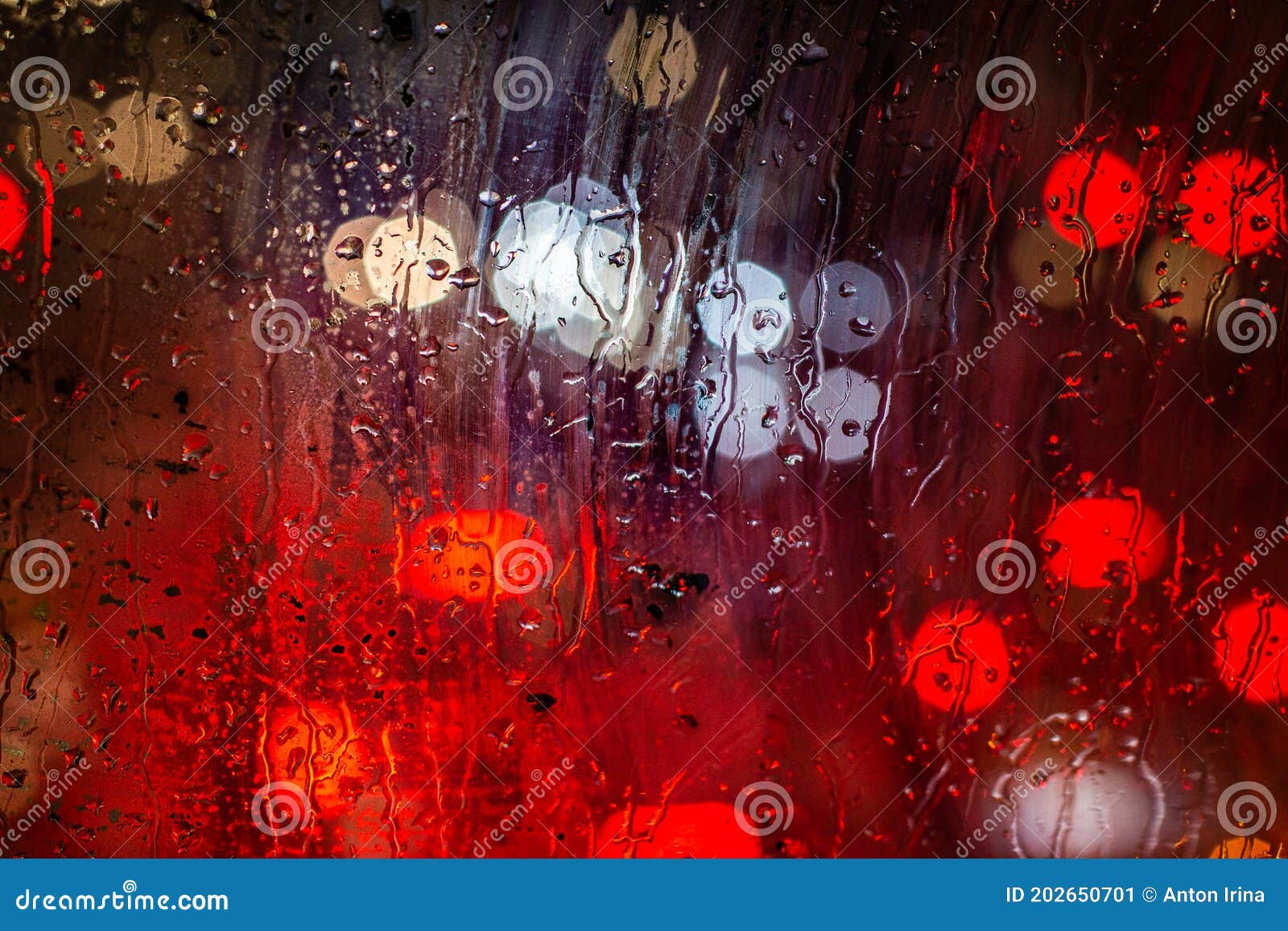 Blurred Traffic Lights And Rain Drops On Window Abstract Bokeh With