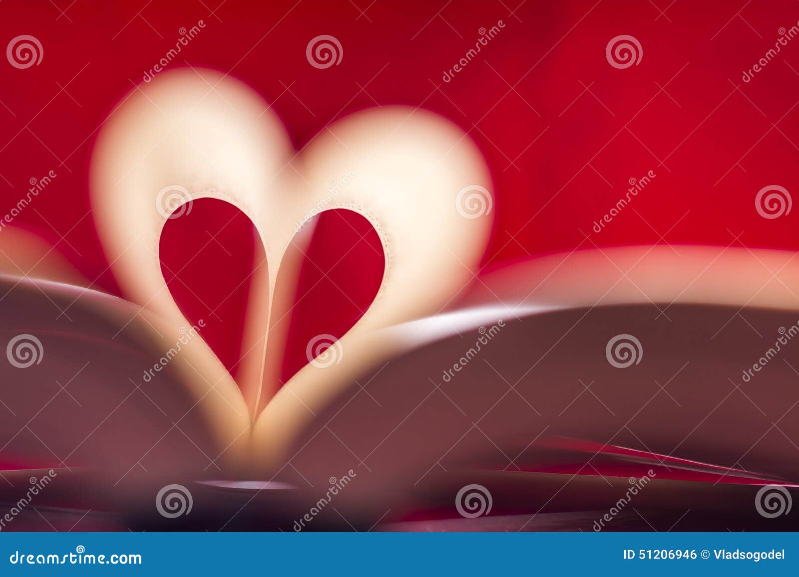 Blurry Heart Made from Book Pages Over Red Background Stock Photo