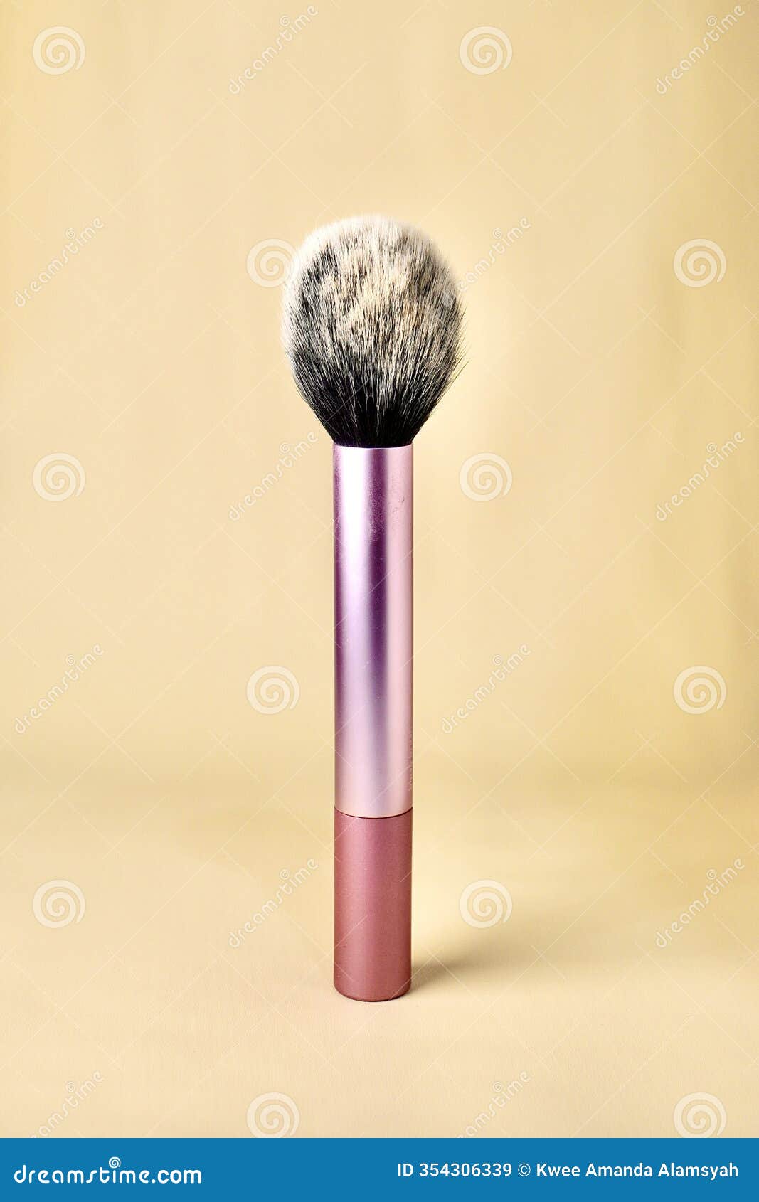 blush brush with pink handle on vertical cream background