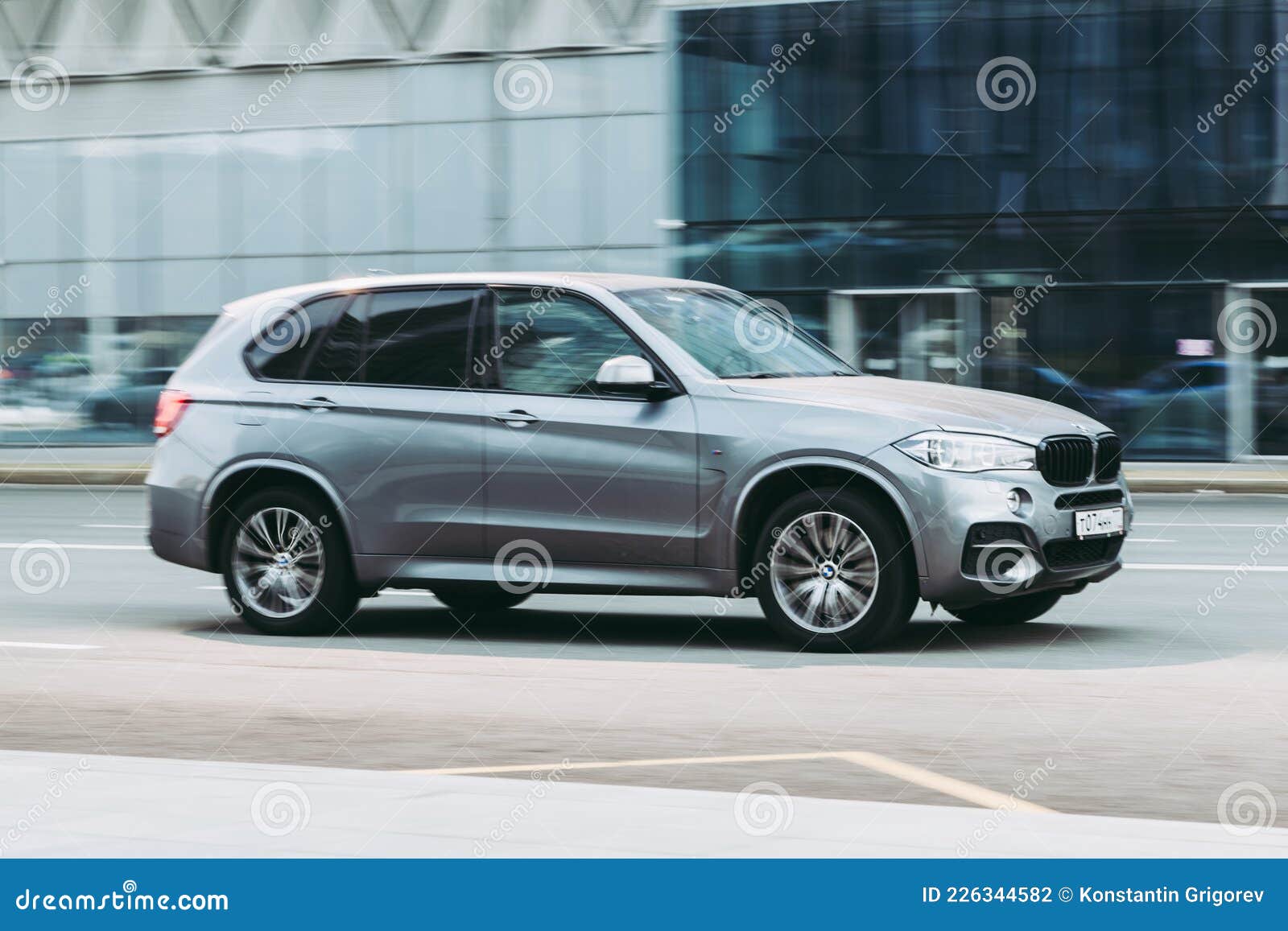 Car BMW X5 Third Generation F15 Driving in City with Motion Blur