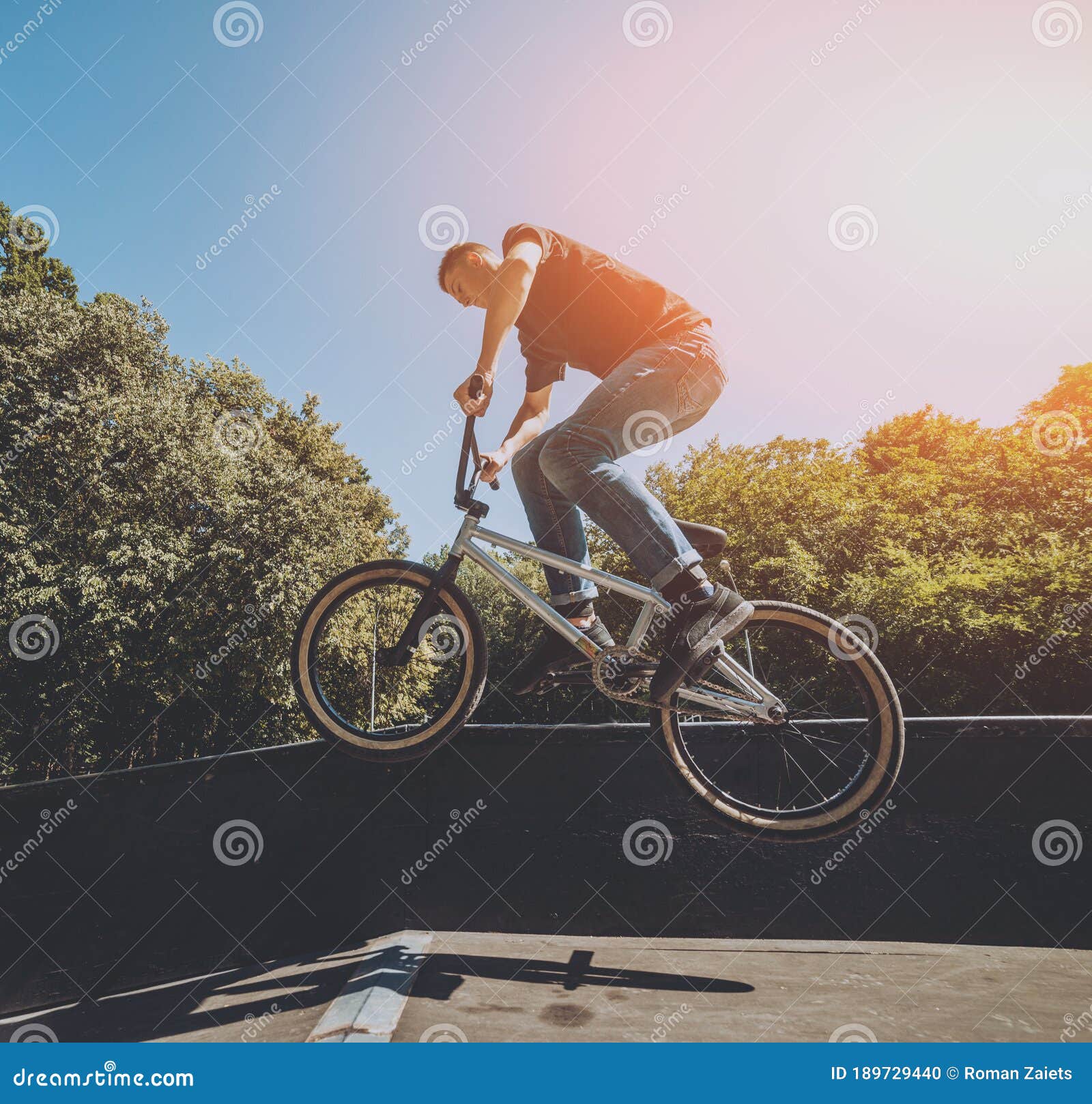 Bmx Rider Performing Tricks at Skatepark. Background. Stock Photo