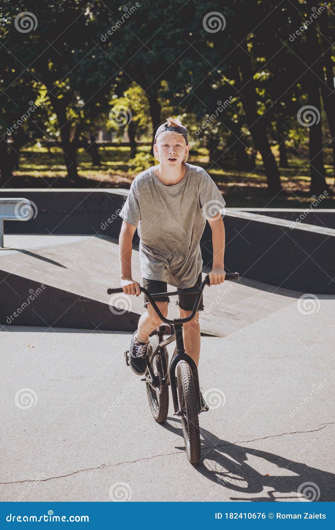 Bmx Rider Performing Tricks at Skatepark. Background. Stock Photo