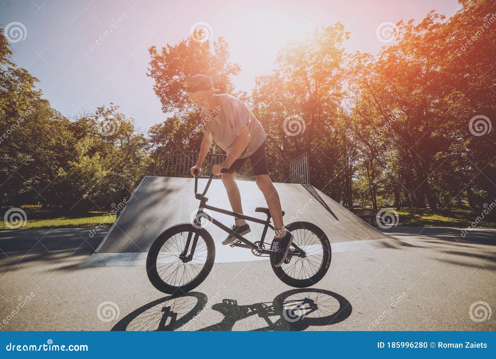 Bmx Rider Performing Tricks at Skatepark. Outdoors. Stock Photo Image