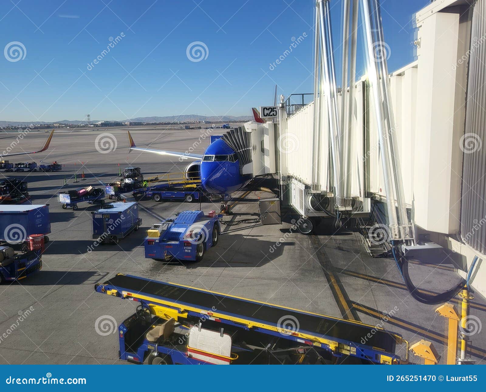 at the airport! cargo workers loading a jet on the tarmac before boarding!