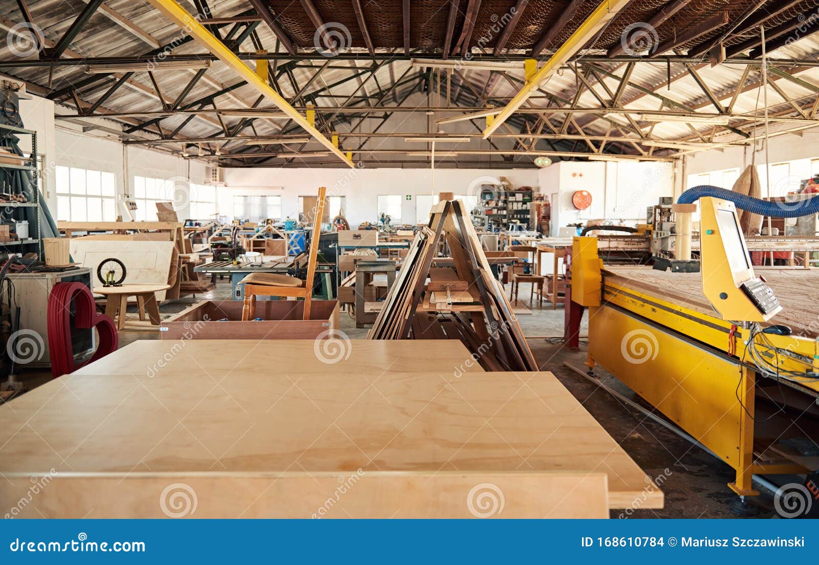 boards sitting on benches in a woodworking shop