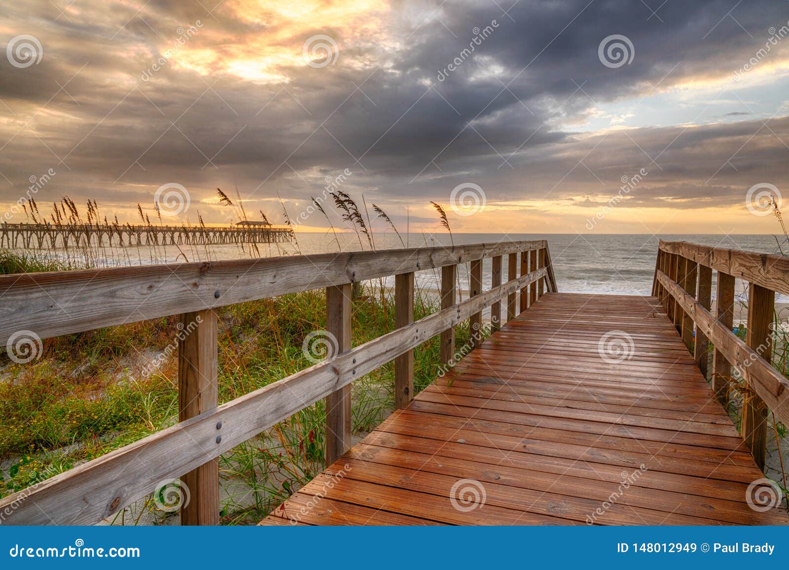 boardwalk leading to the beach at sunrise