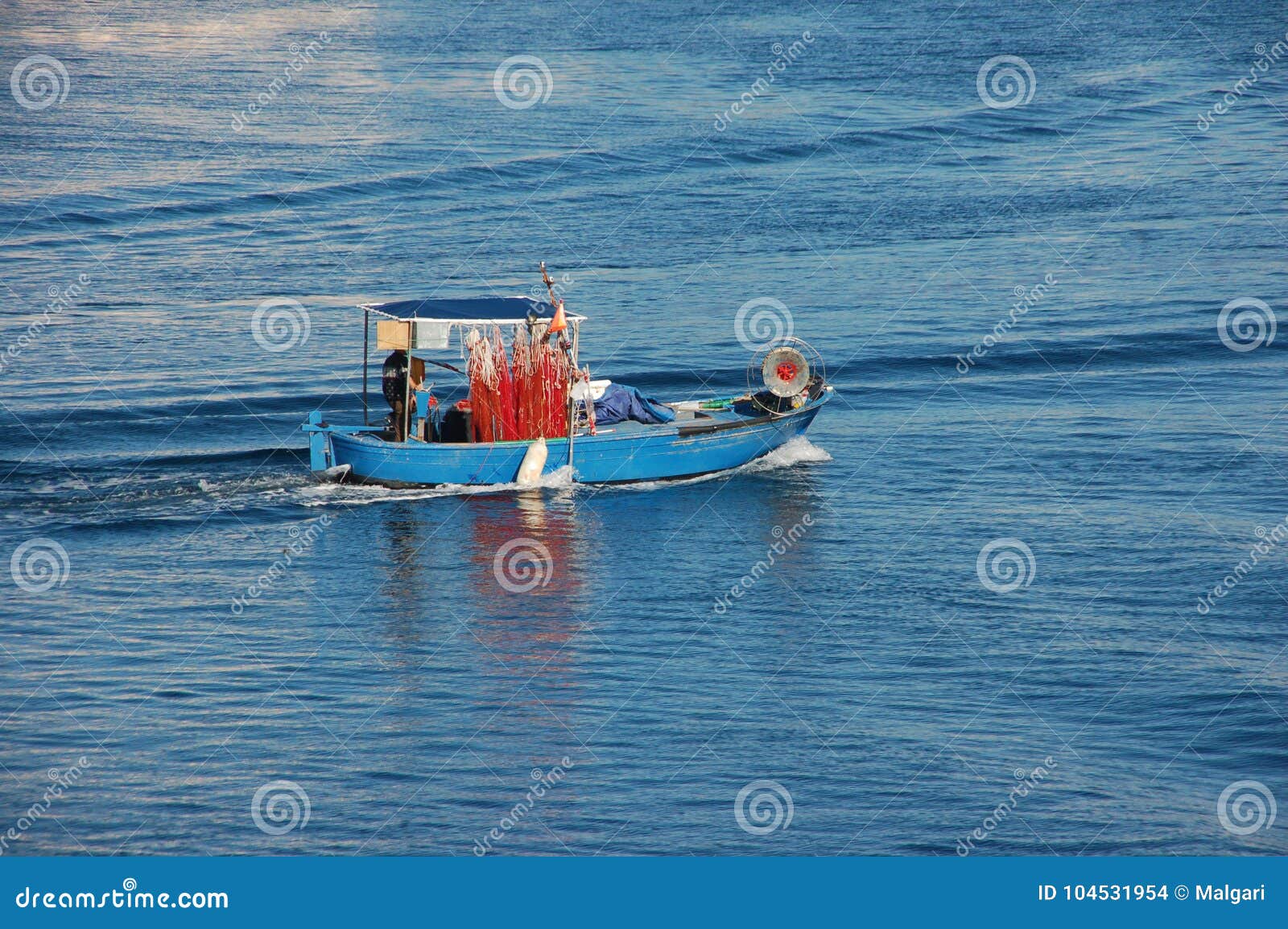 boat of a lone fisherman in navigation for work a