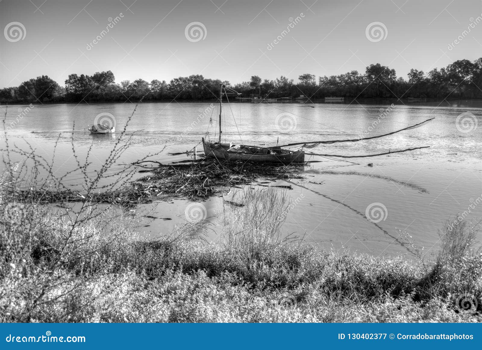 a boat moored surrounded by the debris of the flood of the river