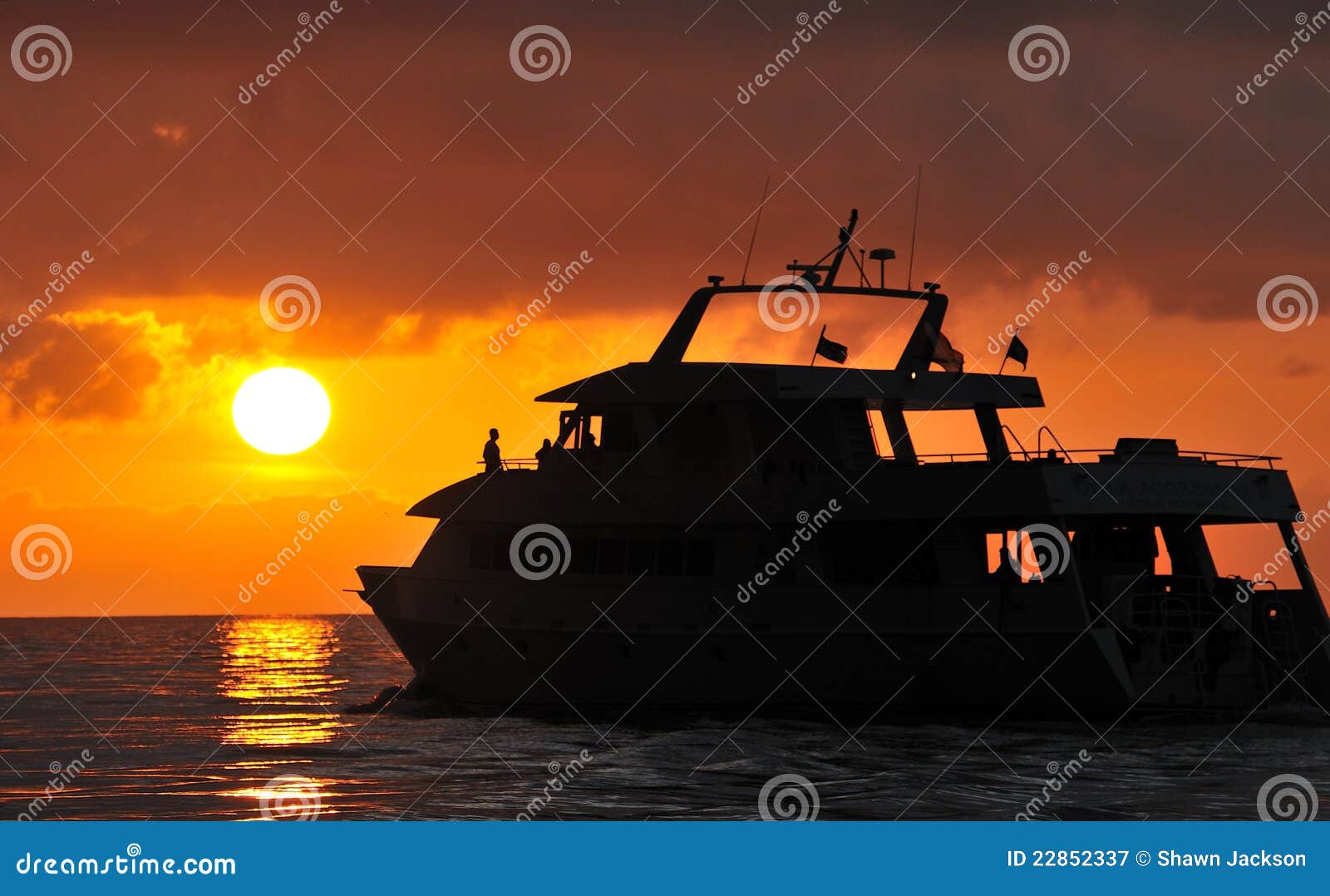 boat silhouetted at sunset