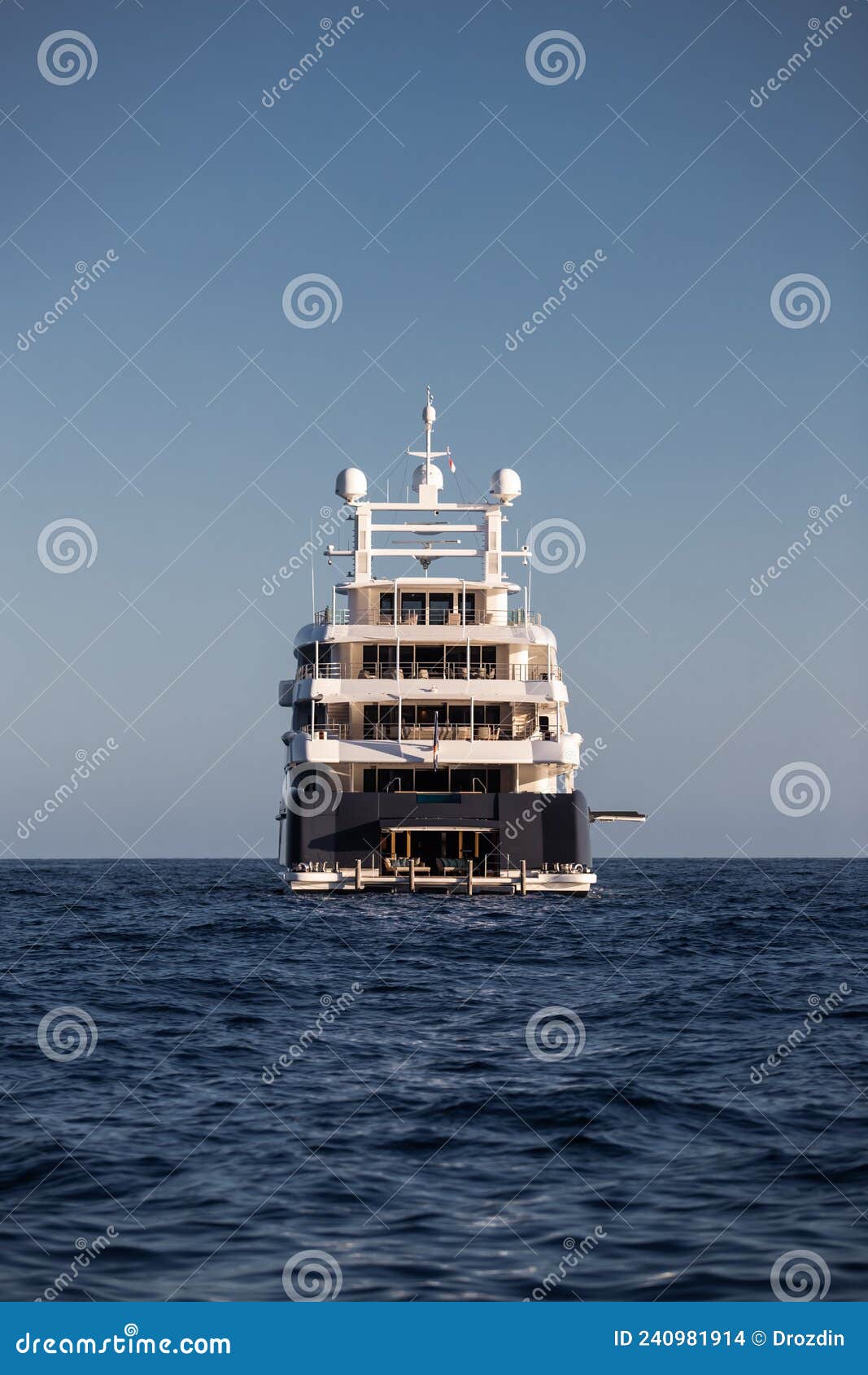 the boat stern of huge yacht in sea at sunny day, glossy board of the motor boat, the chrome plated handrail, megayacht