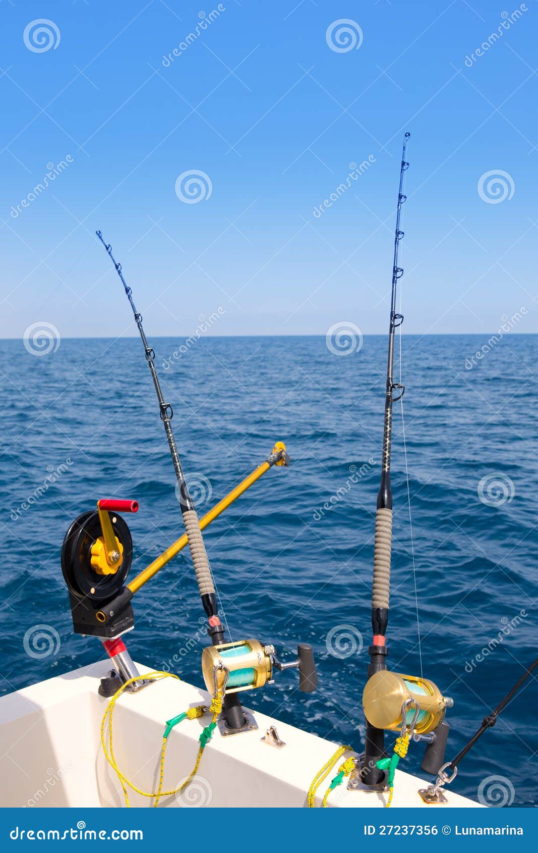 boat trolling fishing gear downrigger and two rods stock