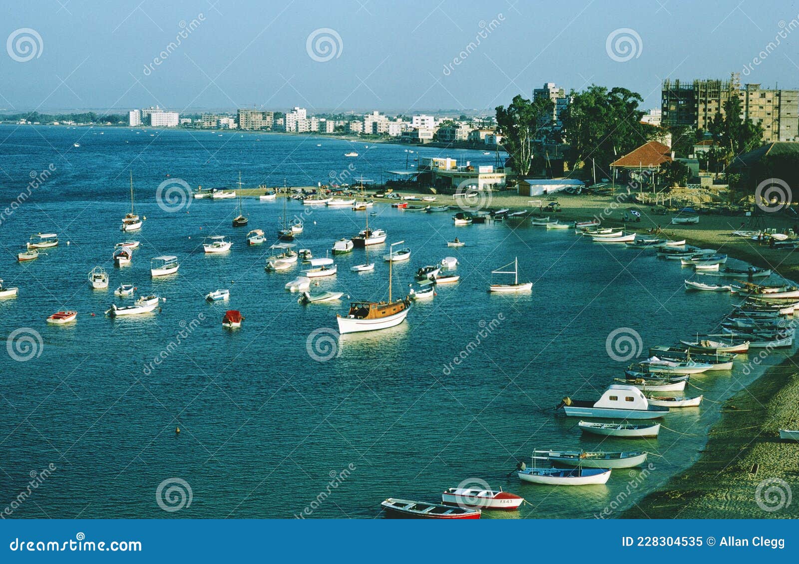 boats at a harbor oat the coast of southern france in 1967 . what a beautiful day .