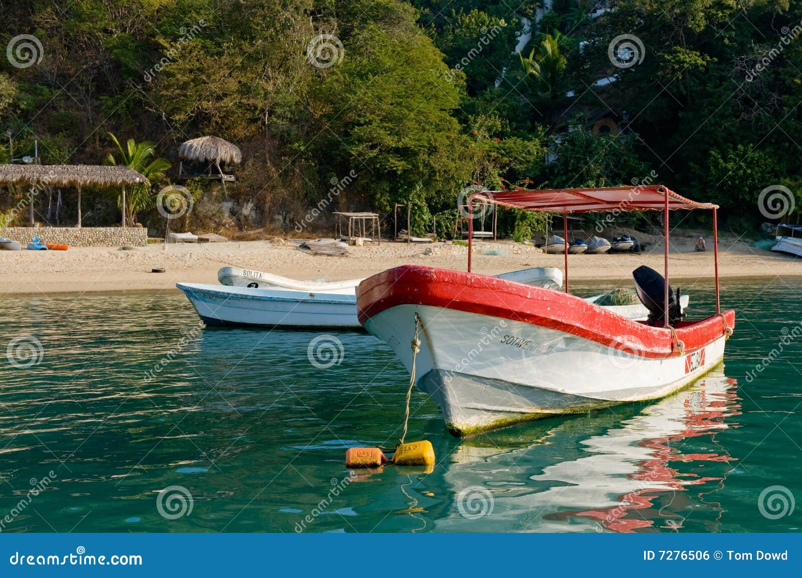 boats moored by scenic beach