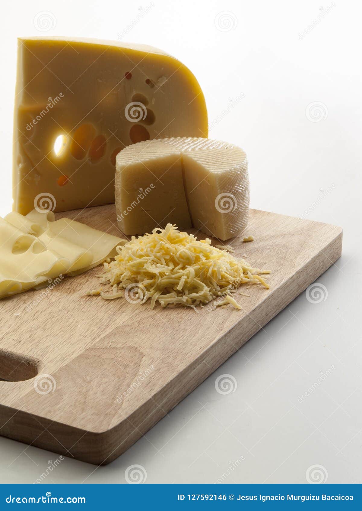 photographic still life with sheep cheeses and to melt with slices and scratches of it on a cutting board