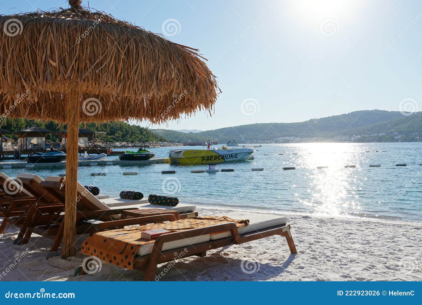 bodrum, turkey - august, 2020 hotel lujo, beautiful aegean sea turquoise blue color and palm trees on the beach. sun