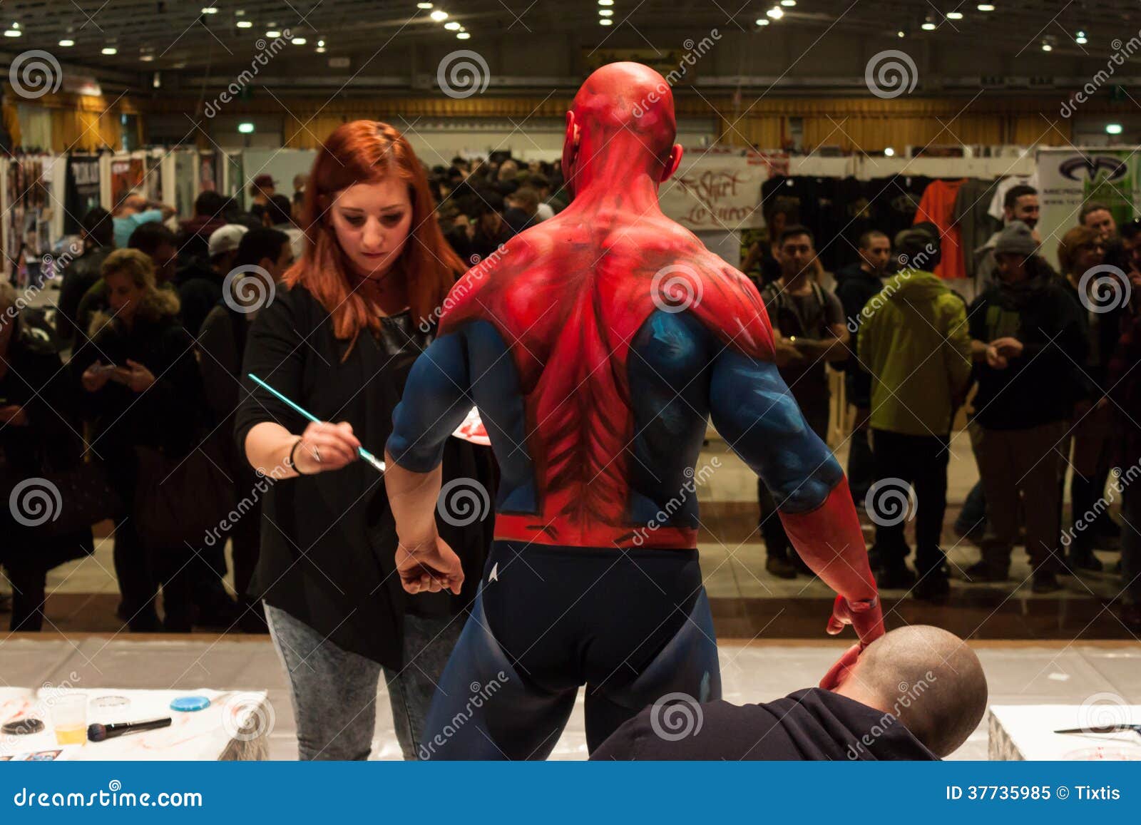 Bodybuilder during a Body Painting Session at Milano Tattoo Convention