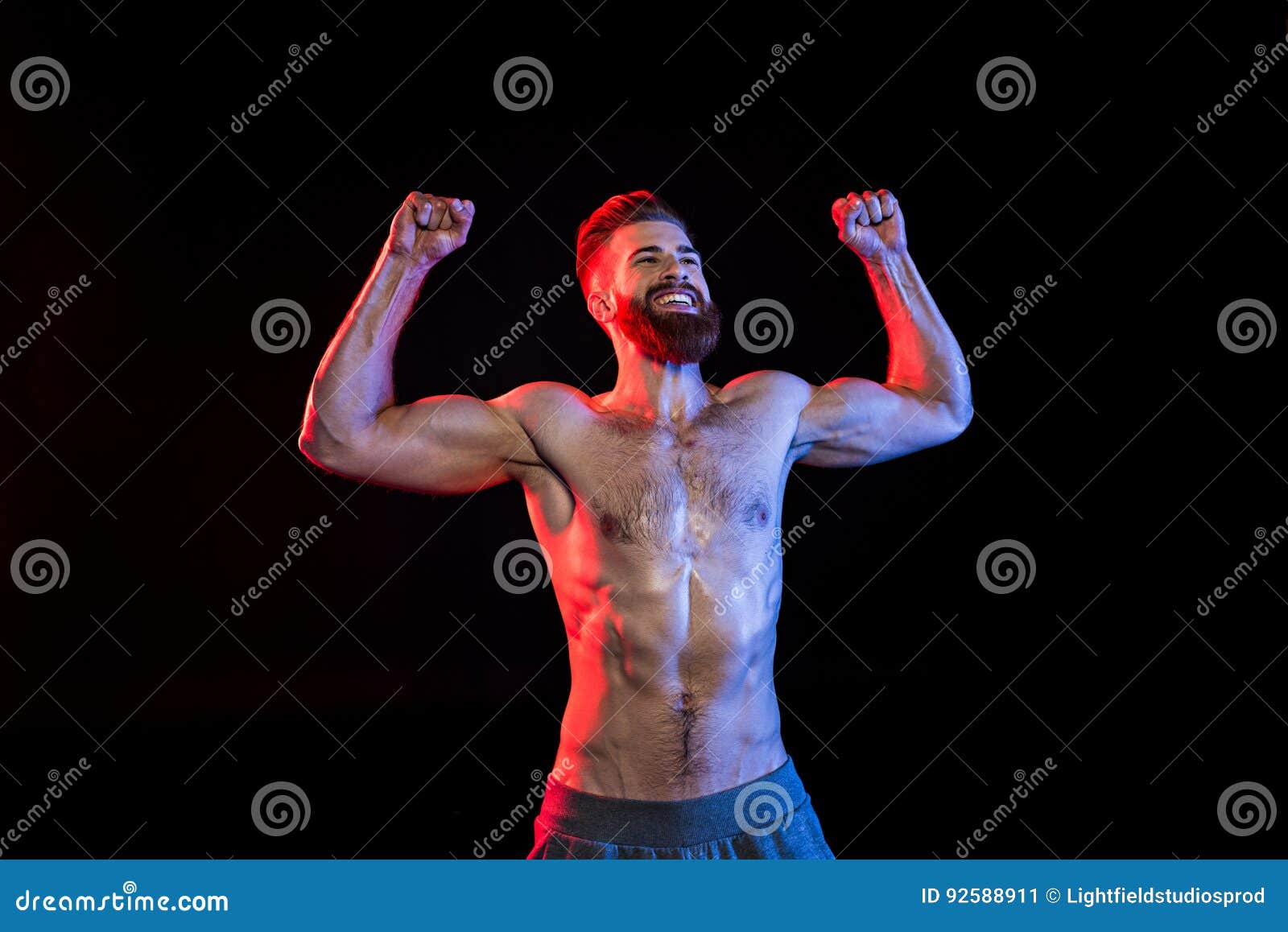 Bodybuilder Celebrating Triumph Isolated on Black with Dramatic