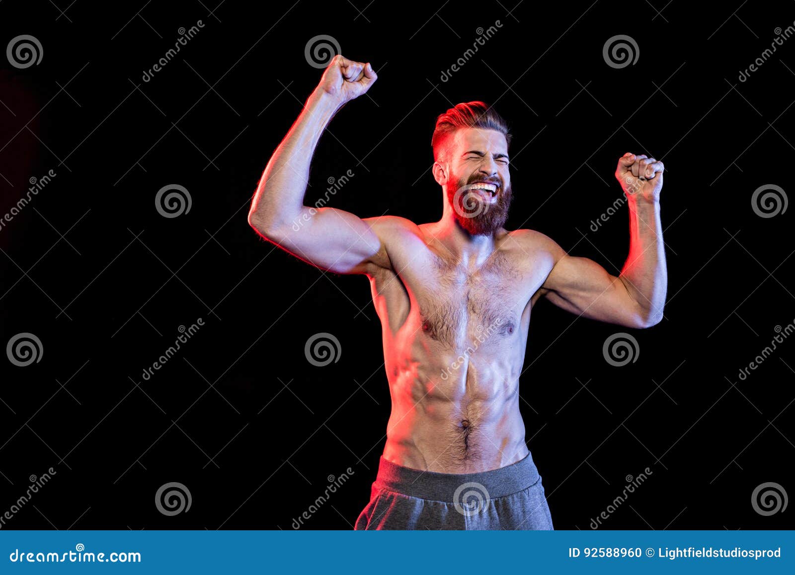 Bodybuilder Celebrating Triumph Isolated on Black with Dramatic