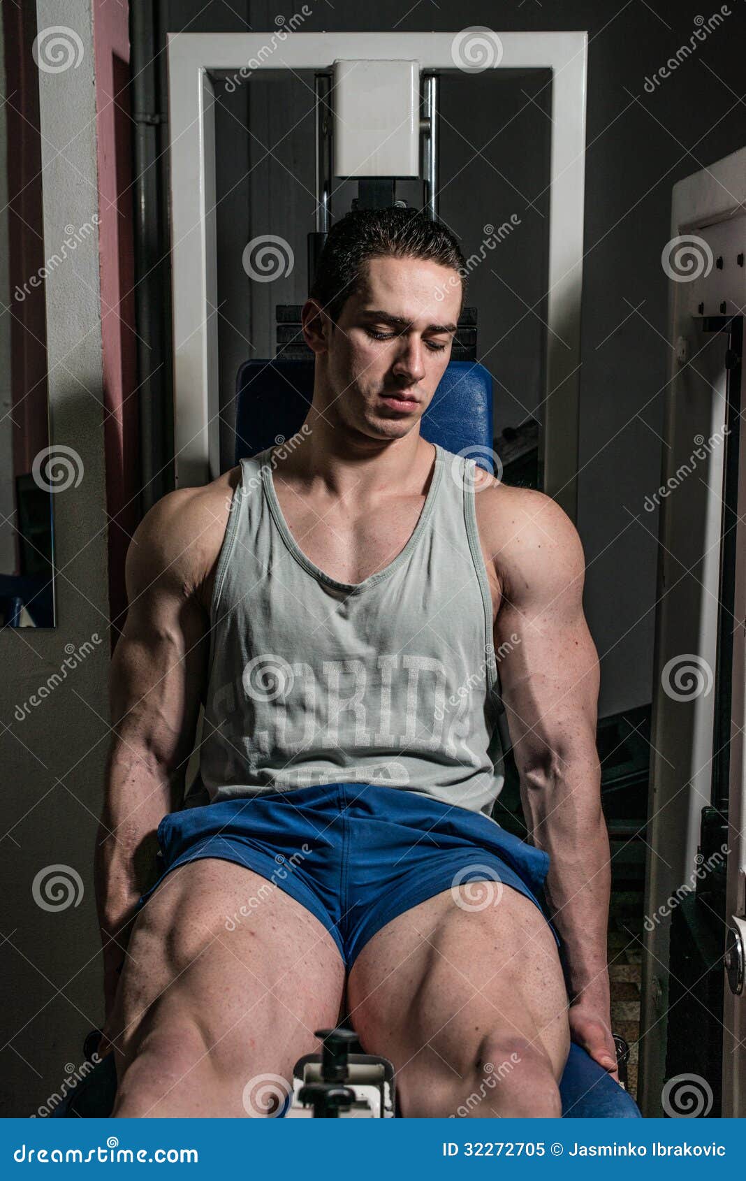 Bodybuilder Doing Heavy Weight Exercise for Legs on Machine Leg