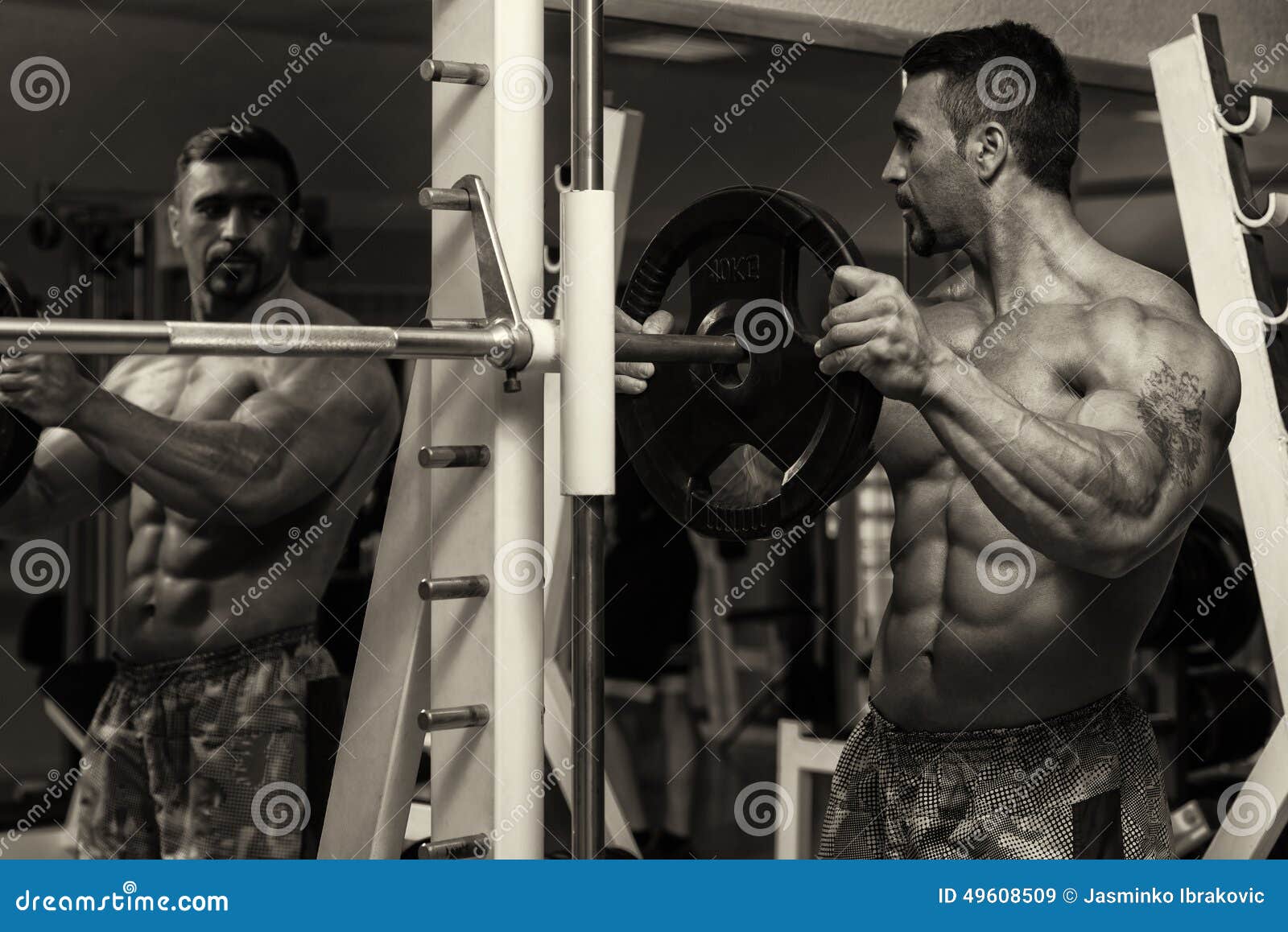 Bodybuilder Putting Weights on Bar in Gym Stock Image Image of