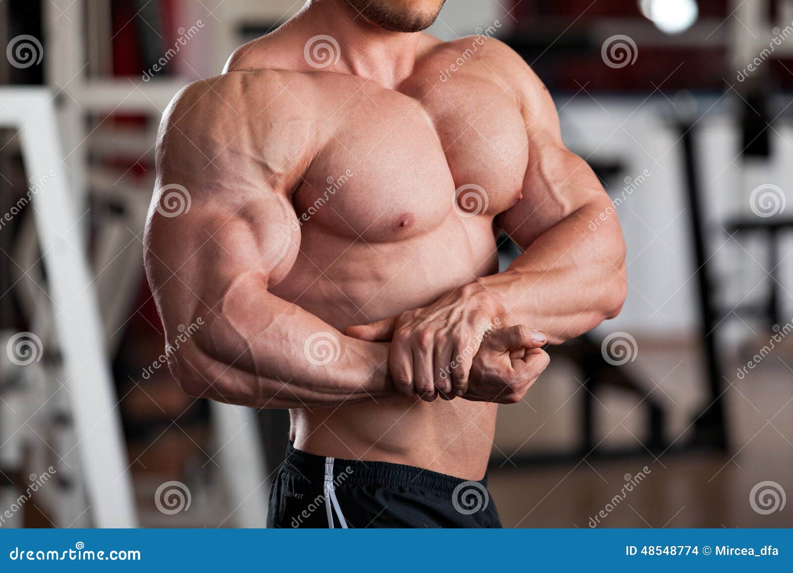 Bodybuilder posing. Pose - chest and biceps on the side. Stock Illustration  | Adobe Stock