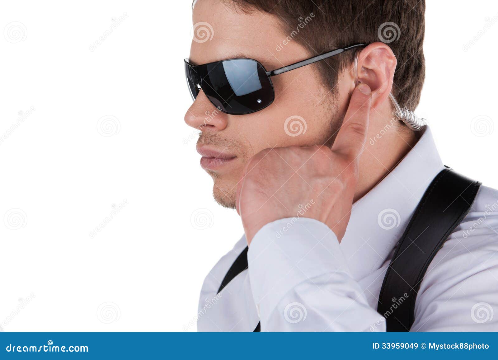 Serious Bodyguard Standing with Sunglasses and Security Earpiece