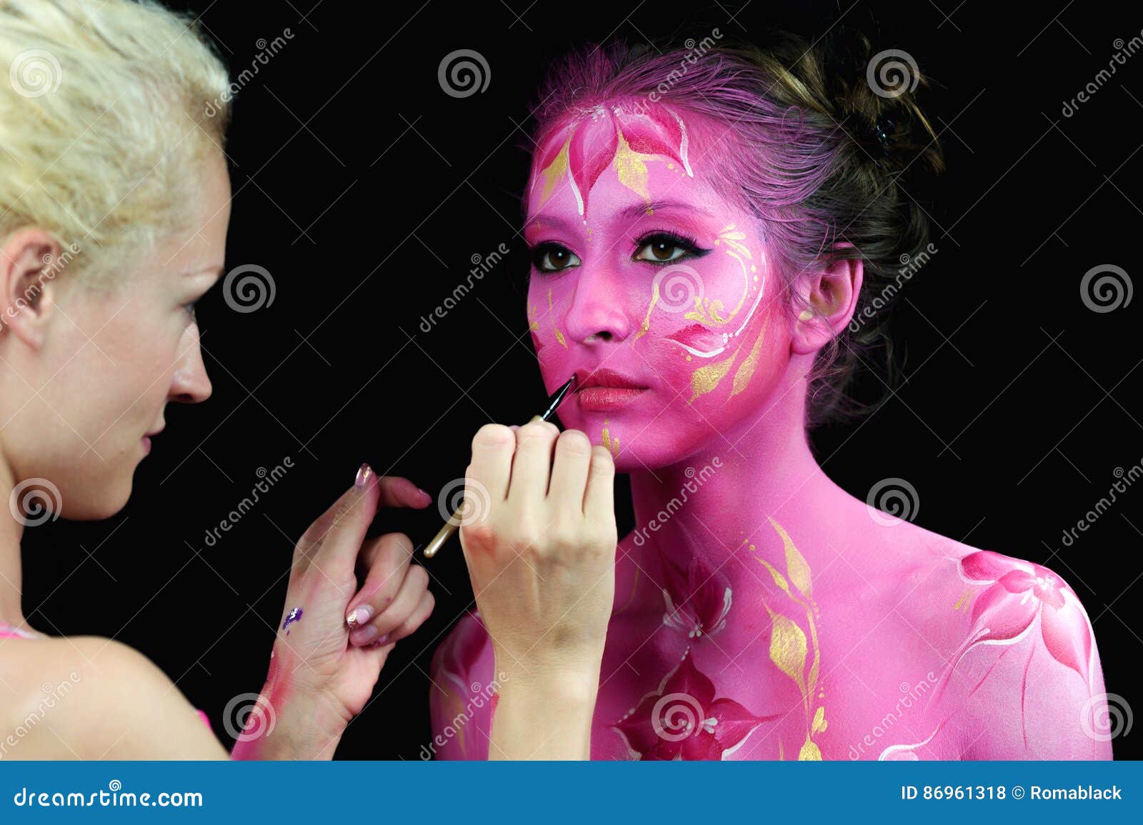 Bodypaint Master in Work, Paints a Model for a Photo Shoot Stock Photo