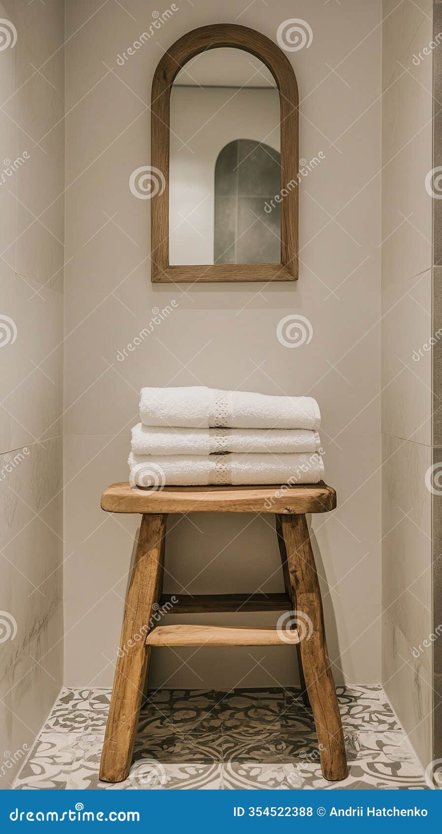 A Bohochic Bathroom with an Arched Mirror Patterned Tiles and a Wooden