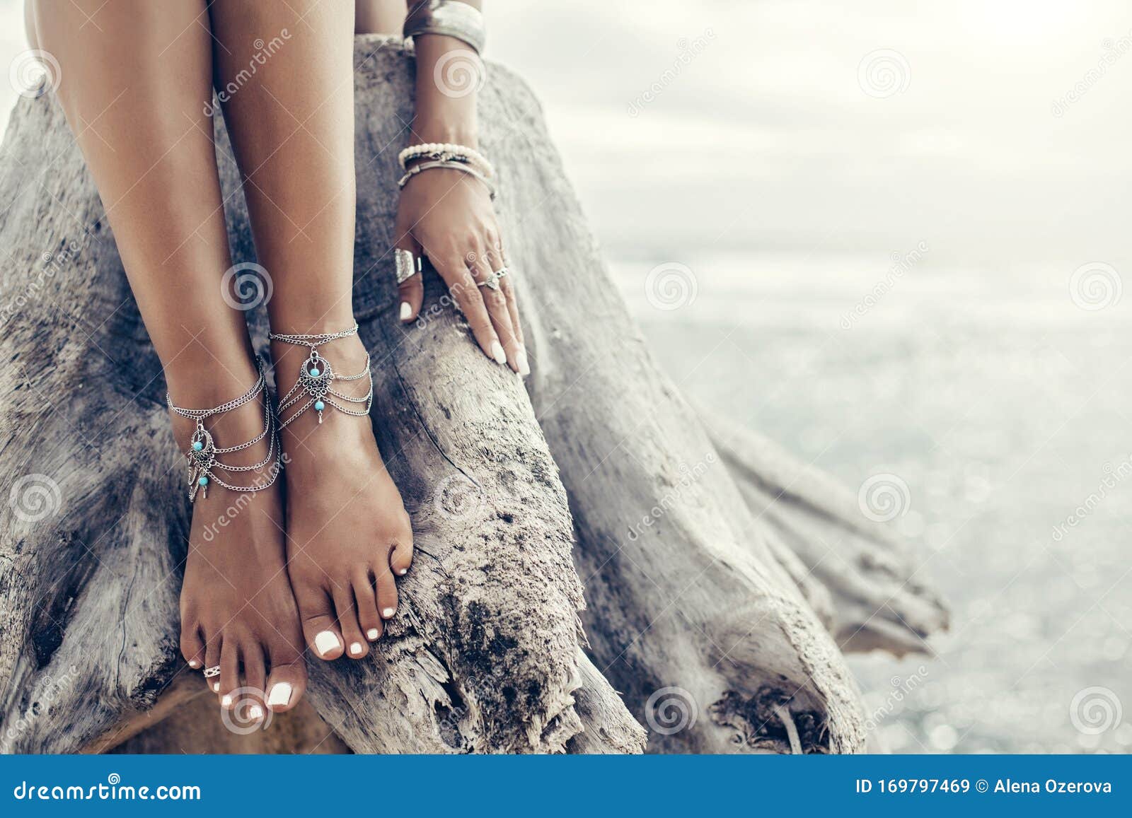 boho girl wearing indian silver jewelry on the beach