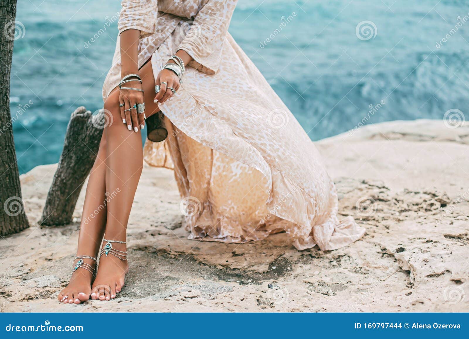 boho girl wearing indian silver jewelry on the beach