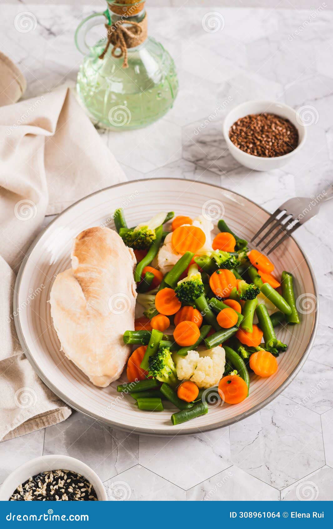 boiled assorted vegetables and chicken fillet for diet food on a plate vertical view