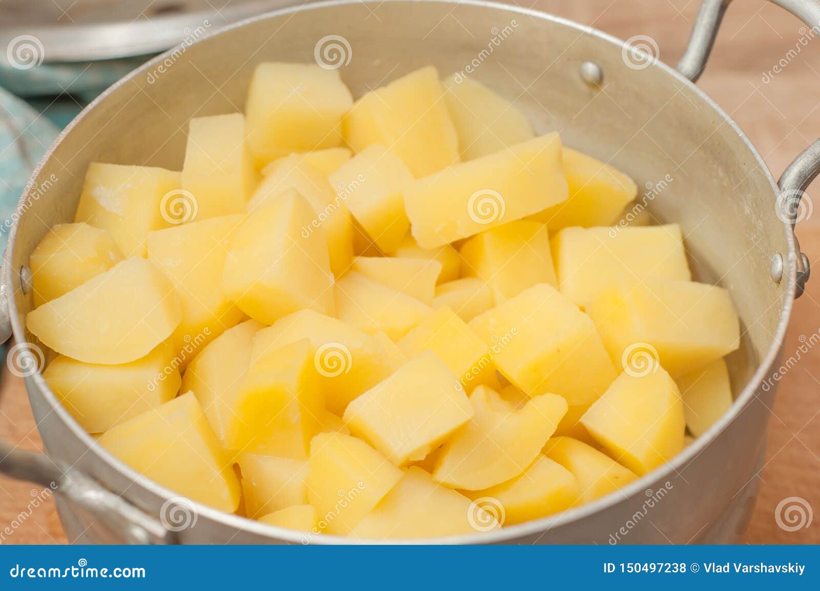 Boiled Diced Potatoes in an Aluminum Pan in the Kitchen Stock Photo
