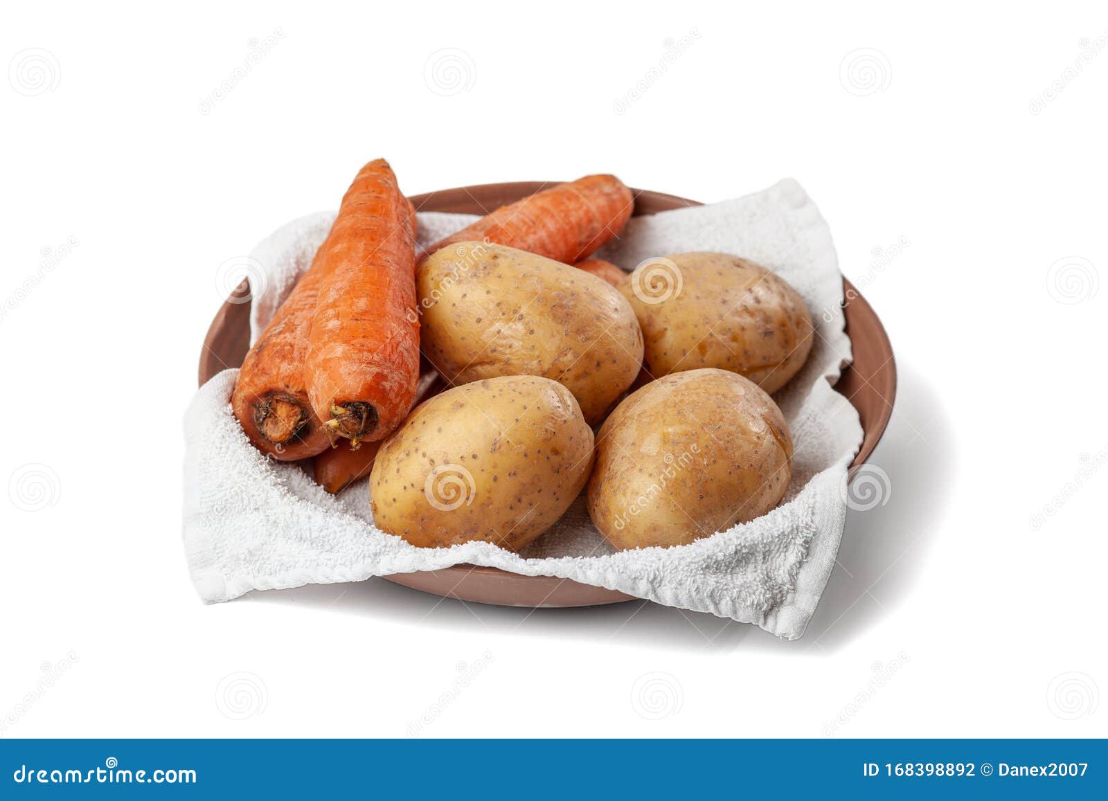 Boiled Potatoes and Carrots on a Towel in a Plate on a White Background