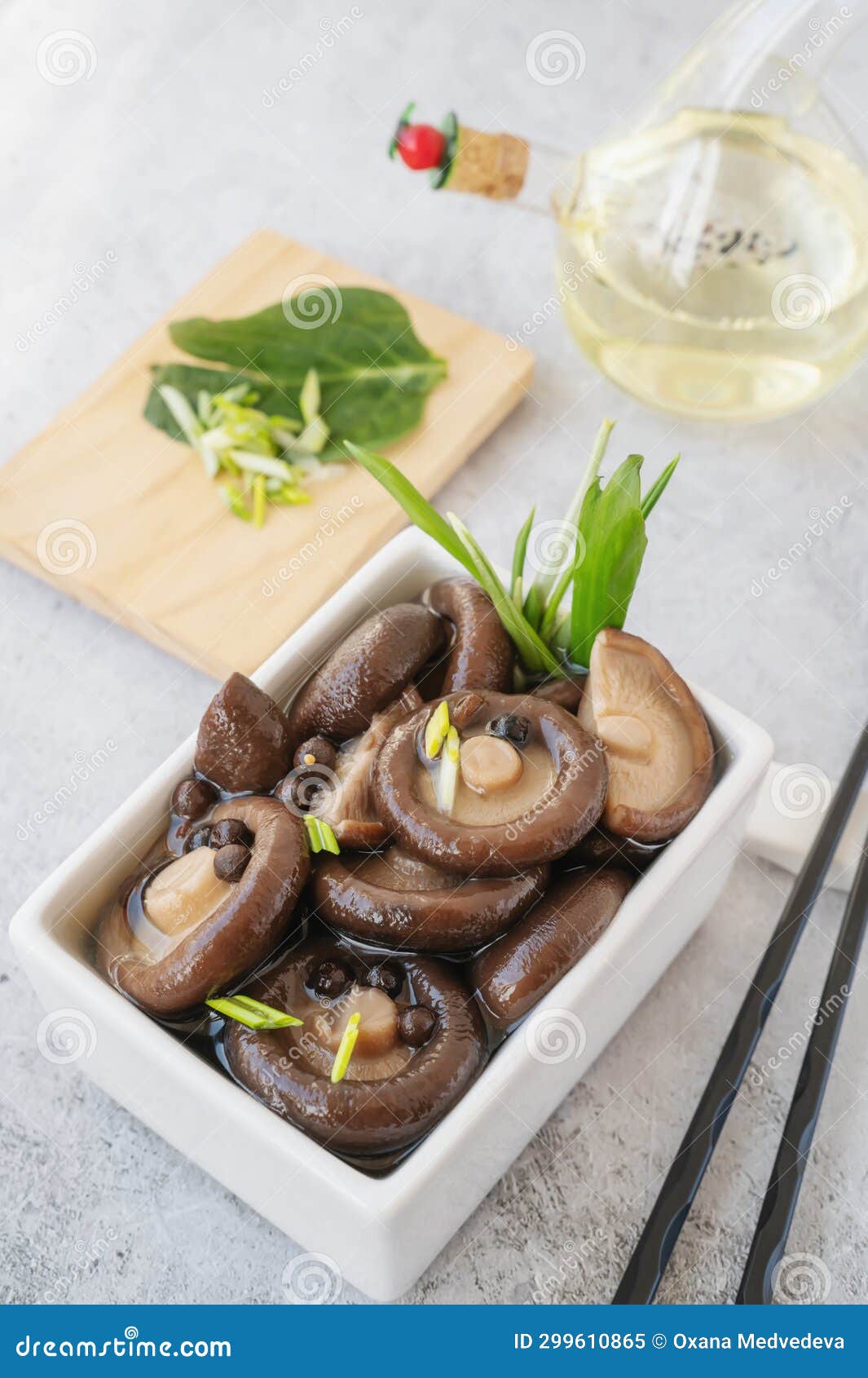 boiled shiitake. boiled shiitakes are prepared for marinade. marinated shiitakes in a square bowl
