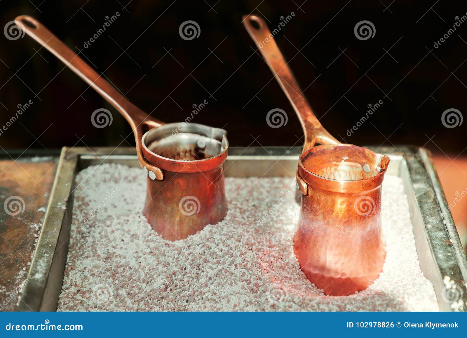Boiled Traditional Turkish Coffee in the Pots on Sand. Stock Photo