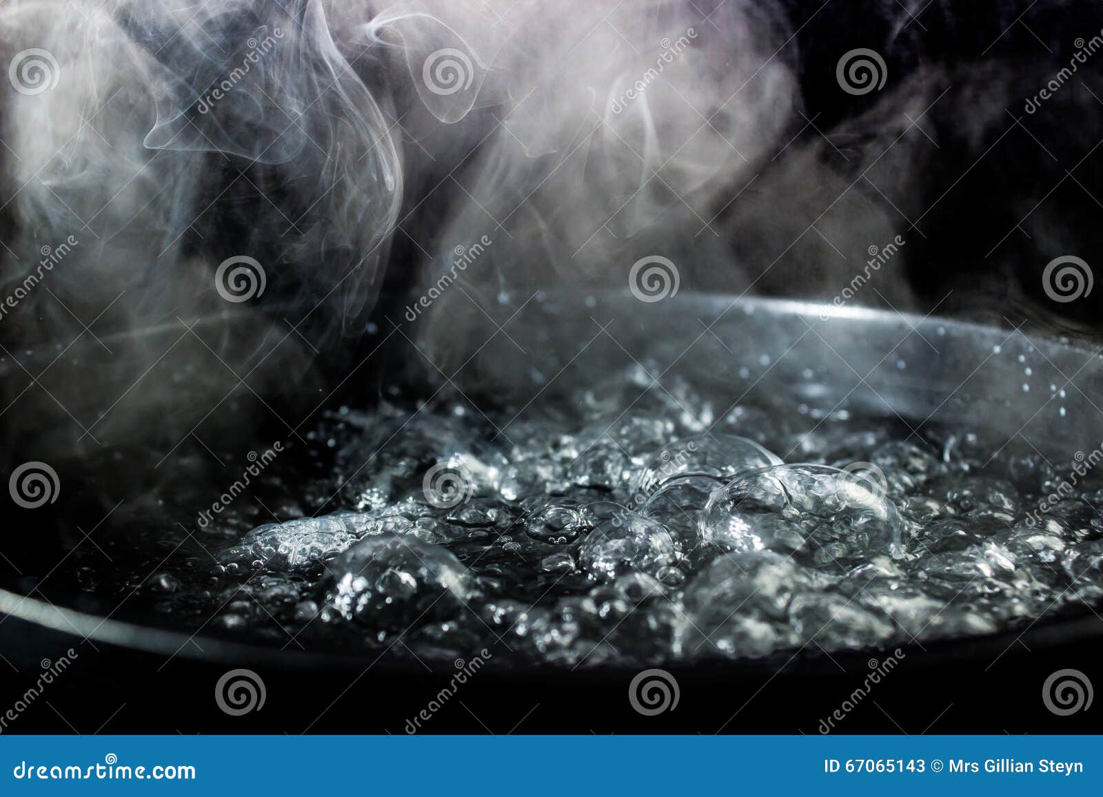 Boil water in a pot on dark background, Stock Video