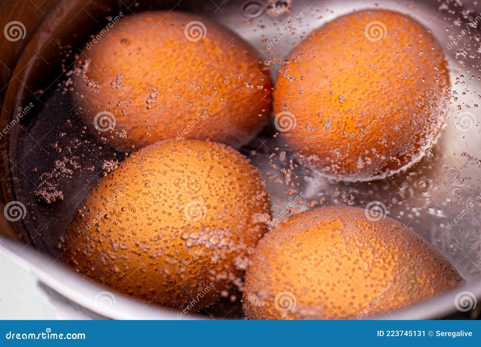 Boiling Water in a Saucepan with Boiled Chicken Eggs Stock Image