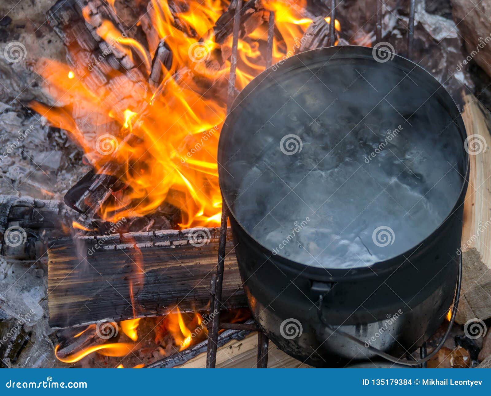 Boiling water at the stake stock photo. Image of kettle 135179384