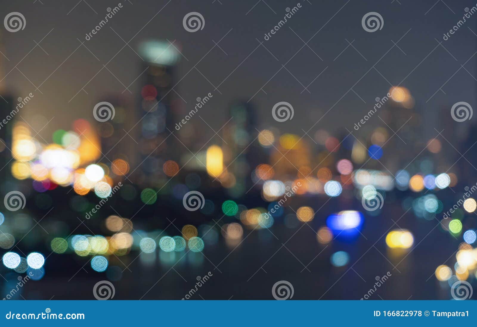 bokeh background of skyscraper buildings in downtown. urban city with lights, blurry photo at night time.  illuminated cityscape