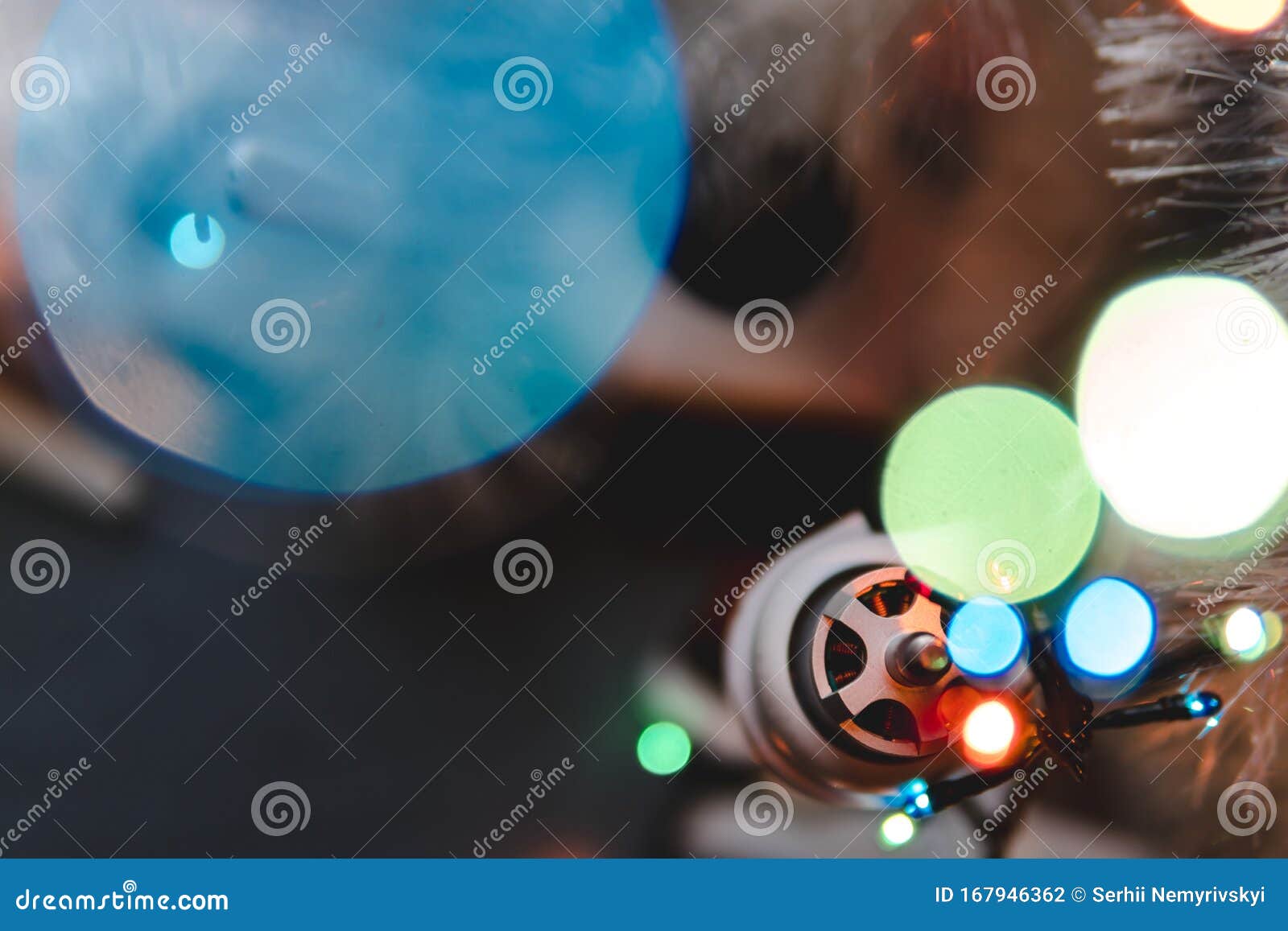 bokeh, selective focus, best christmas pressent, gift drone on a gray wooden table background. lights bokeh, top view, christmas