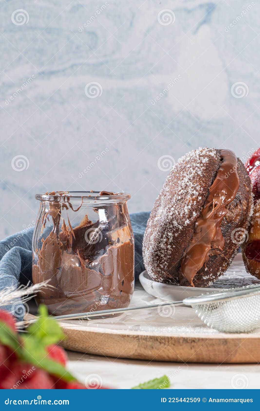 bolas de berlim, or `berlin balls`. portuguese fried dough with sugar, filled with chocolate or raspberry jam. portuguese fried