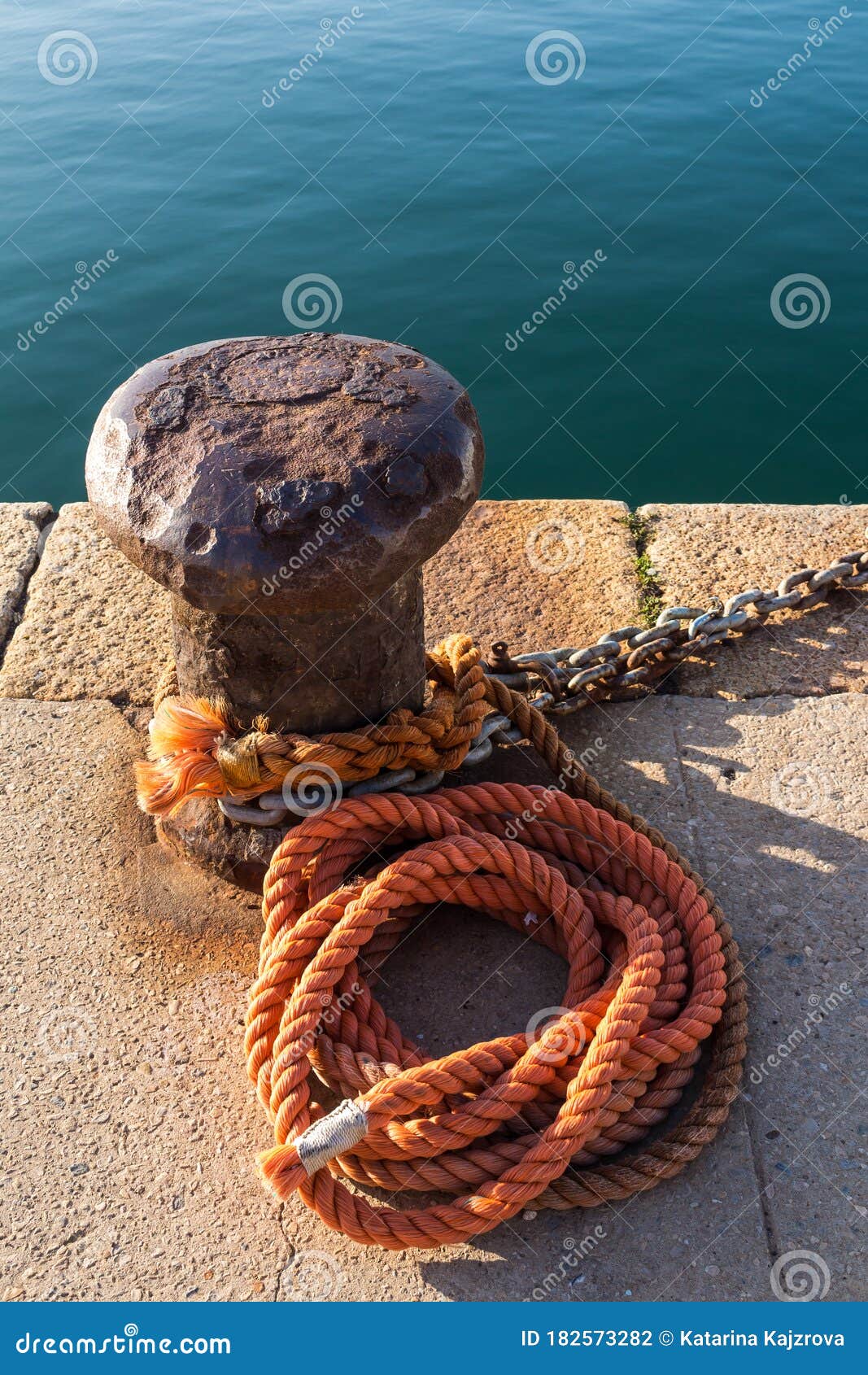 Bollard, Orange Roap and a Sea Stock Photo - Image of nautical