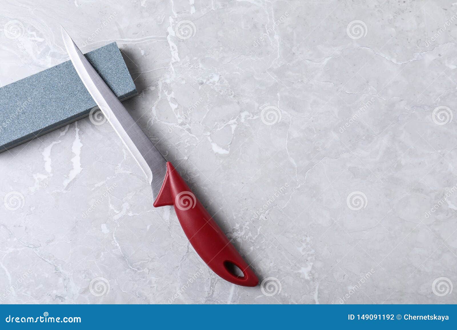 Boning Knife, Sharpening Stone on Grey Background, Flat Lay Stock Photo