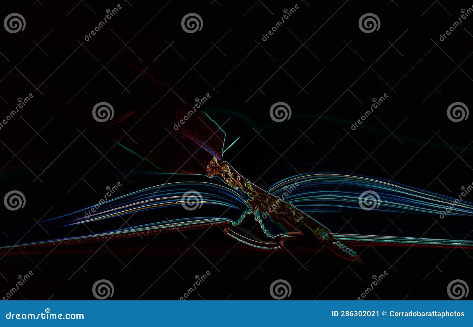 a book and a pen blurs against a black night background
