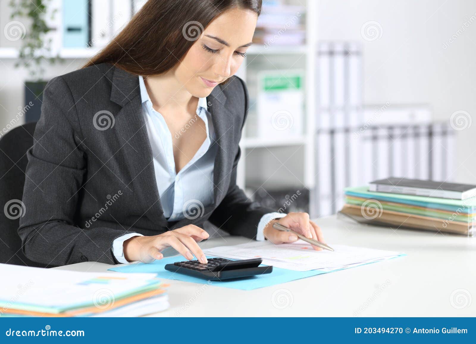 bookkeeper calculates on calculator sitting at the office