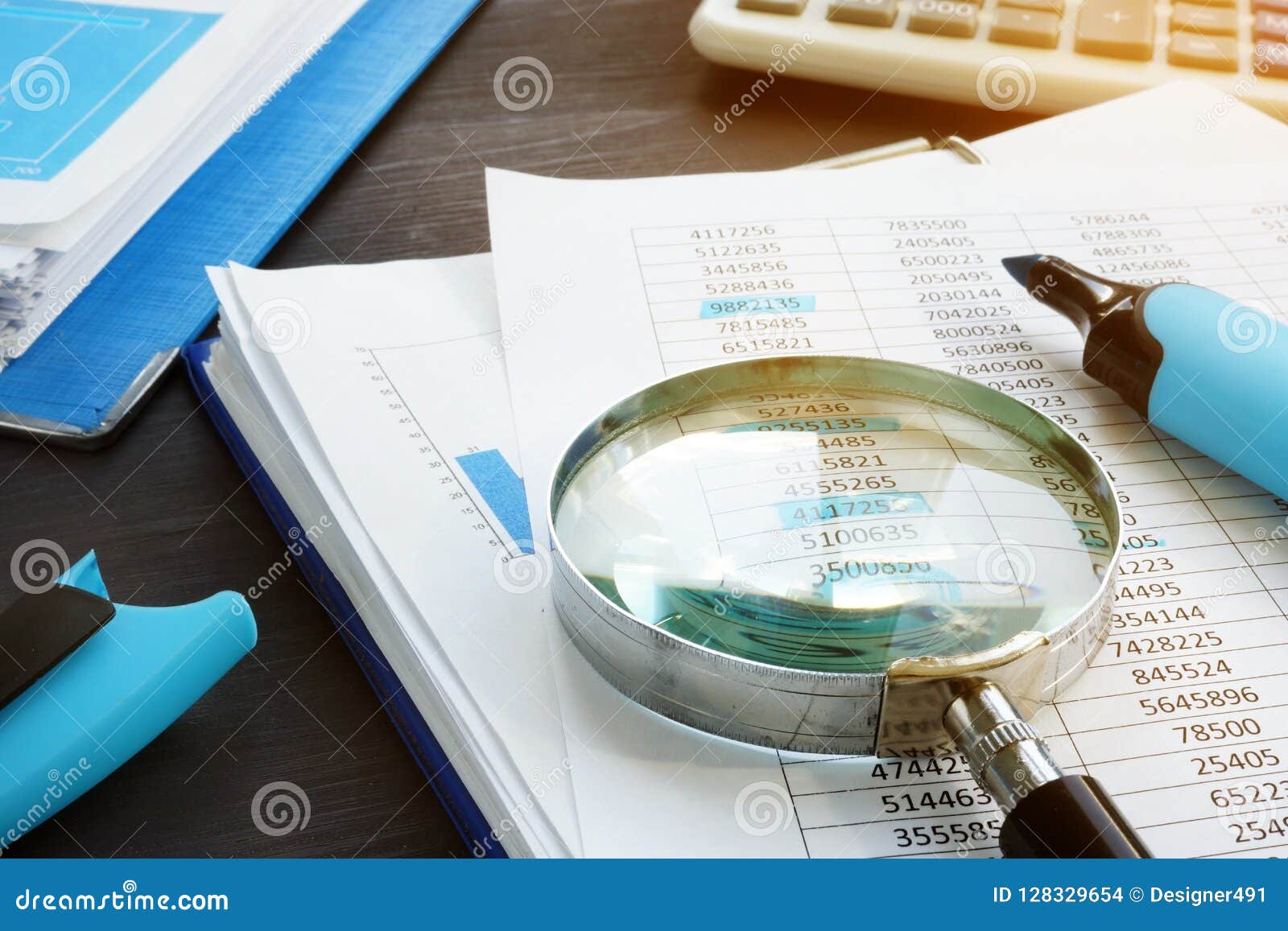 bookkeeping and audit. magnifying glass and business documents.