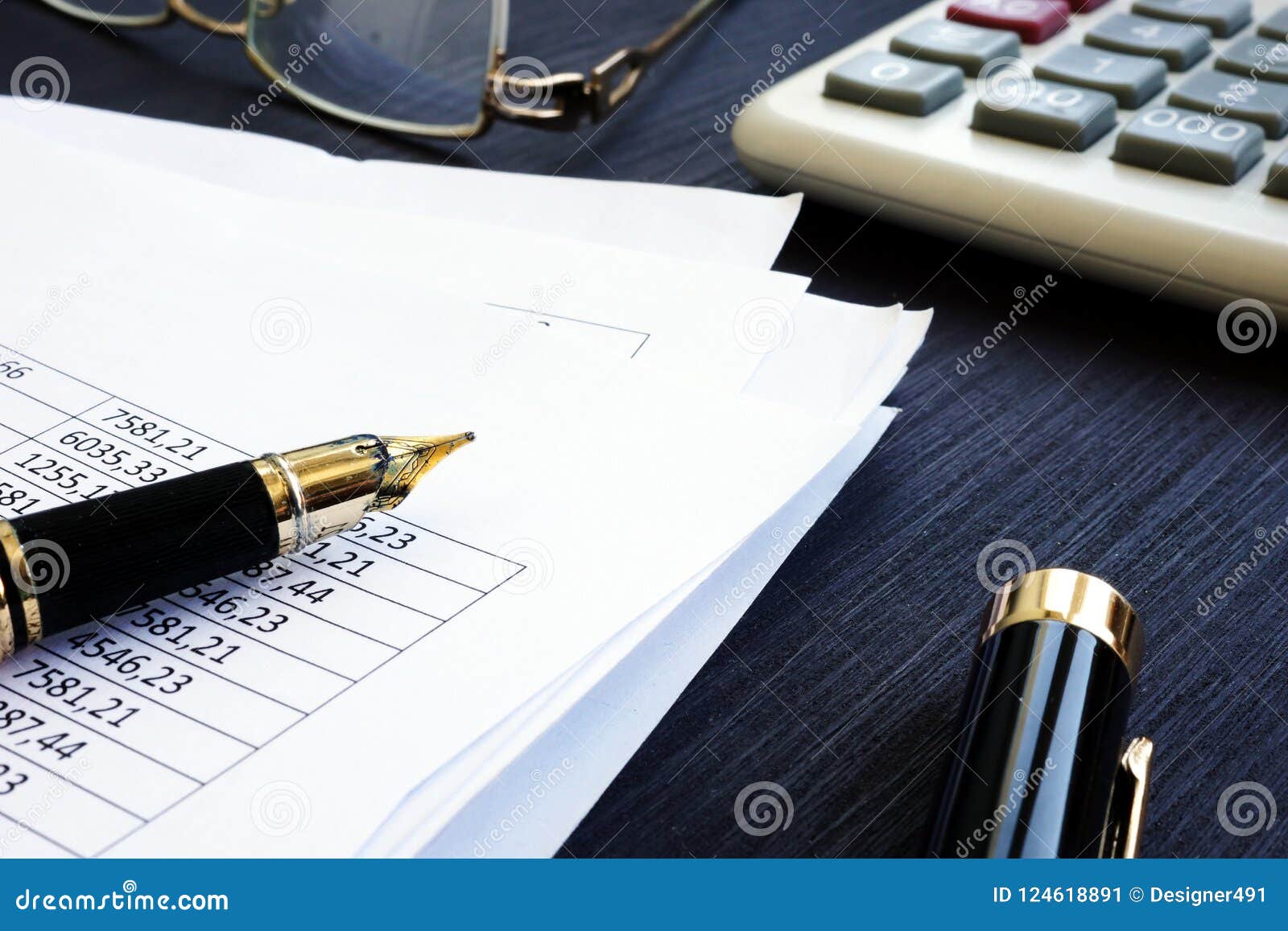 bookkeeping. financial report with figures and calculator on a desk.