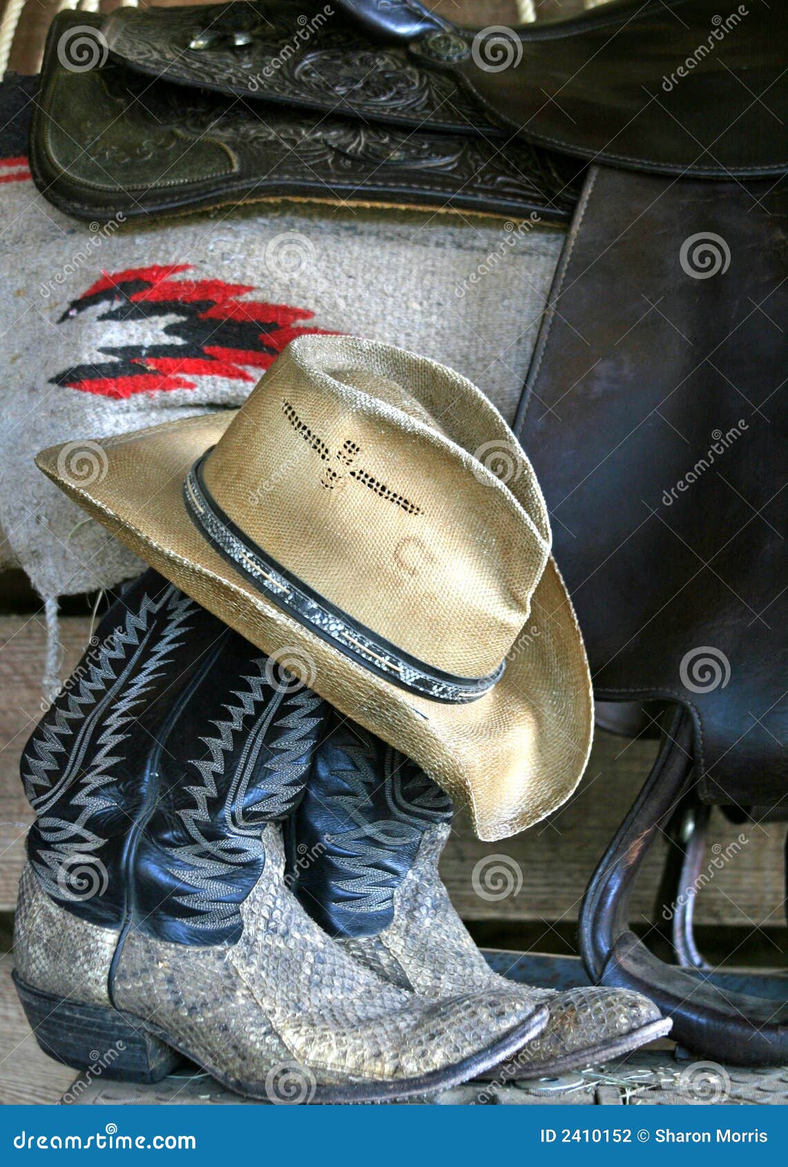 Boots, hat and saddle stock photo. Image of western, blanket 2410152