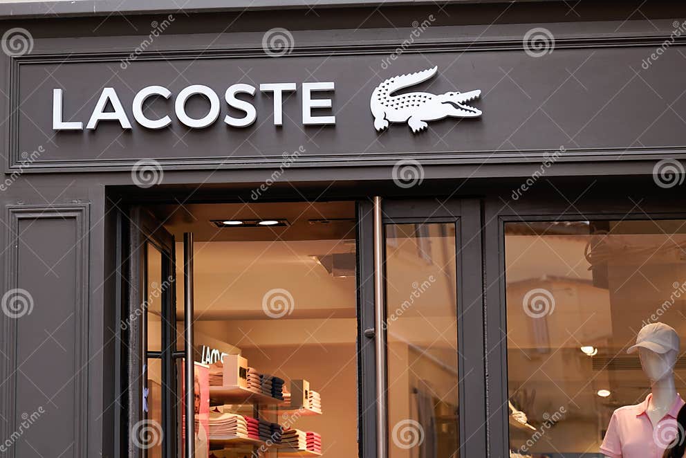 Lacoste Boutique Brand Logo and Sign Text on Facade Entrance Fashion ...